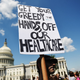 A protester holds a sign during a demonstration of Democratic Senators to oppose the repeal of the Affordable Care Act and its replacement on Capitol Hill on June 21, 2017, in Washington, DC.